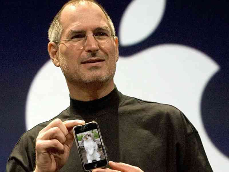 'checkItOut.jpg' - pictured is a photo of Steve Jobs at the 2007 announcement of iPhone. iPhone is edited to show a photograph of a little bunny rabbit instead of the Home Screen.